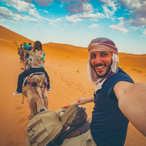 happy-nomad-man-taking-crazy-selfie-during-camel--2048x1365